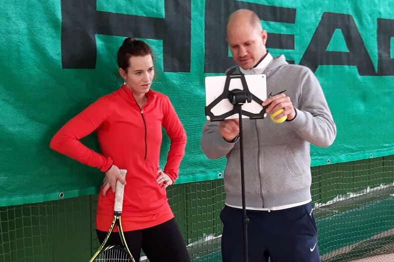 Florian Meier coaching a student courtside at an OTI session