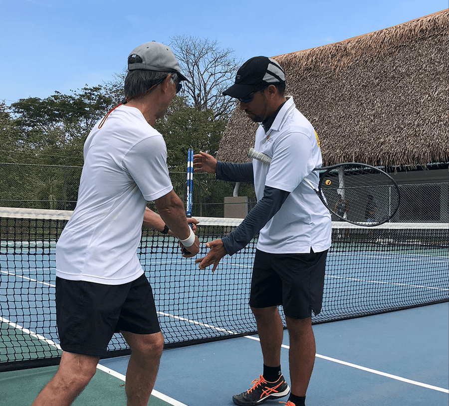 The OTI instructor team on court coaching a clinic